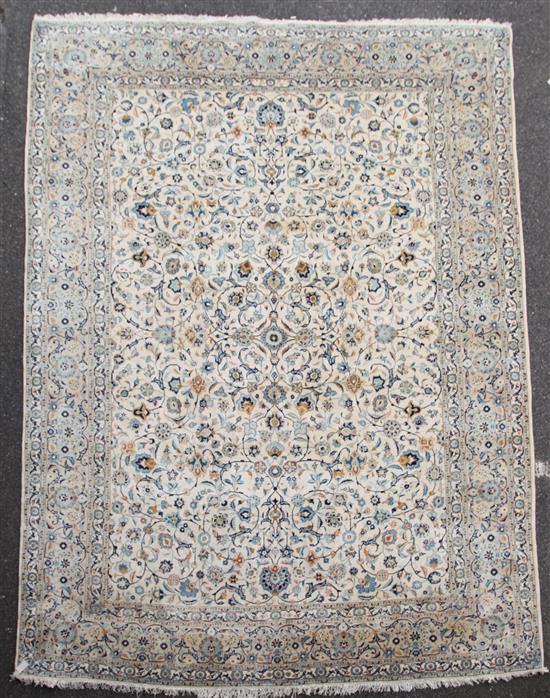 A Tabriz cream ground carpet, 12ft 6in. by 9ft 9in.